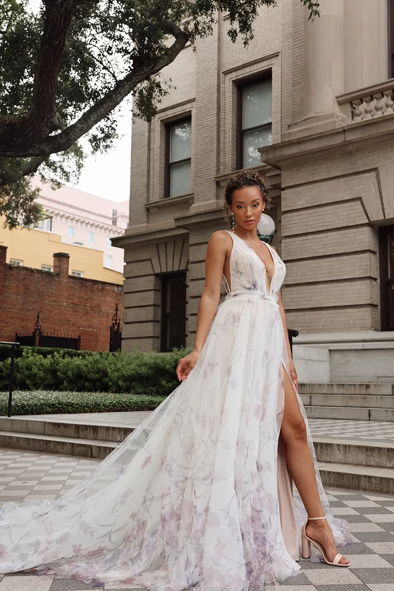 model is wearing a sleeveless floral multicolored bridal gown a-line silhouette