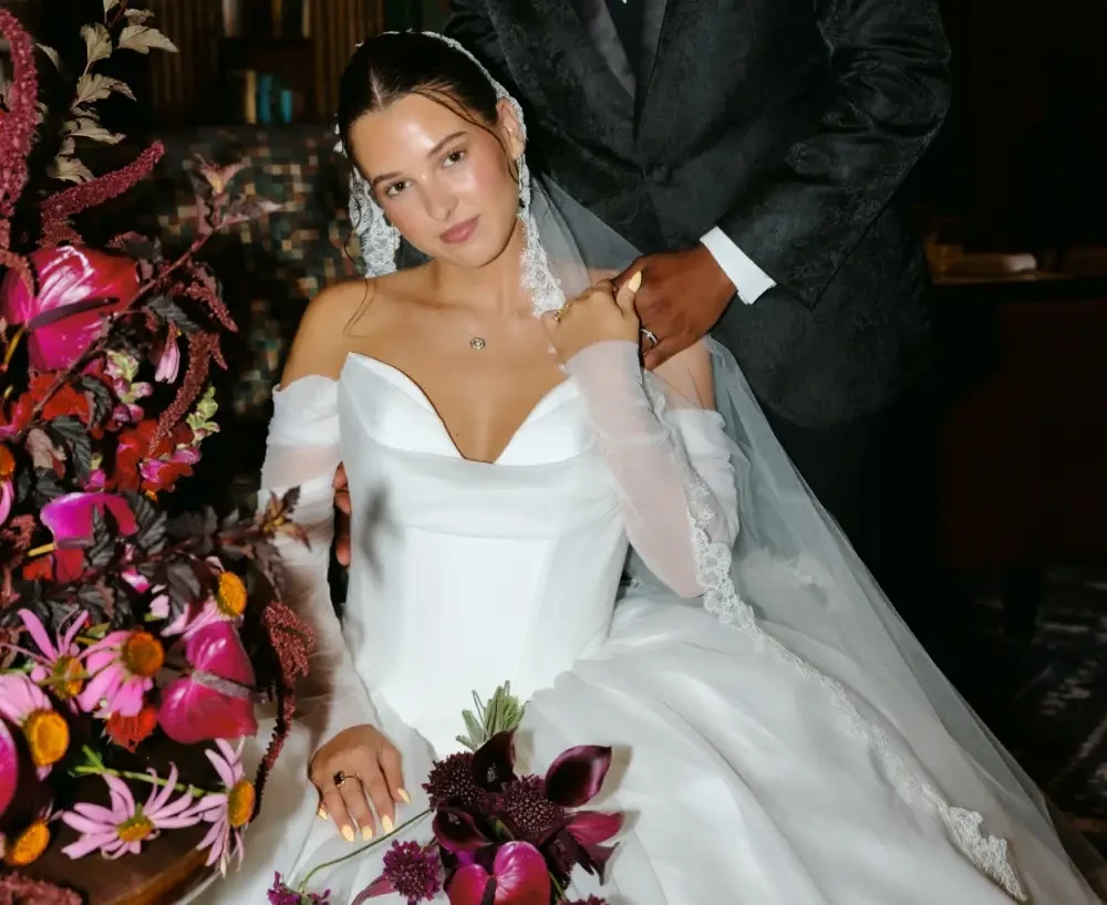 image shows a model in a wedding dress at a fashion show